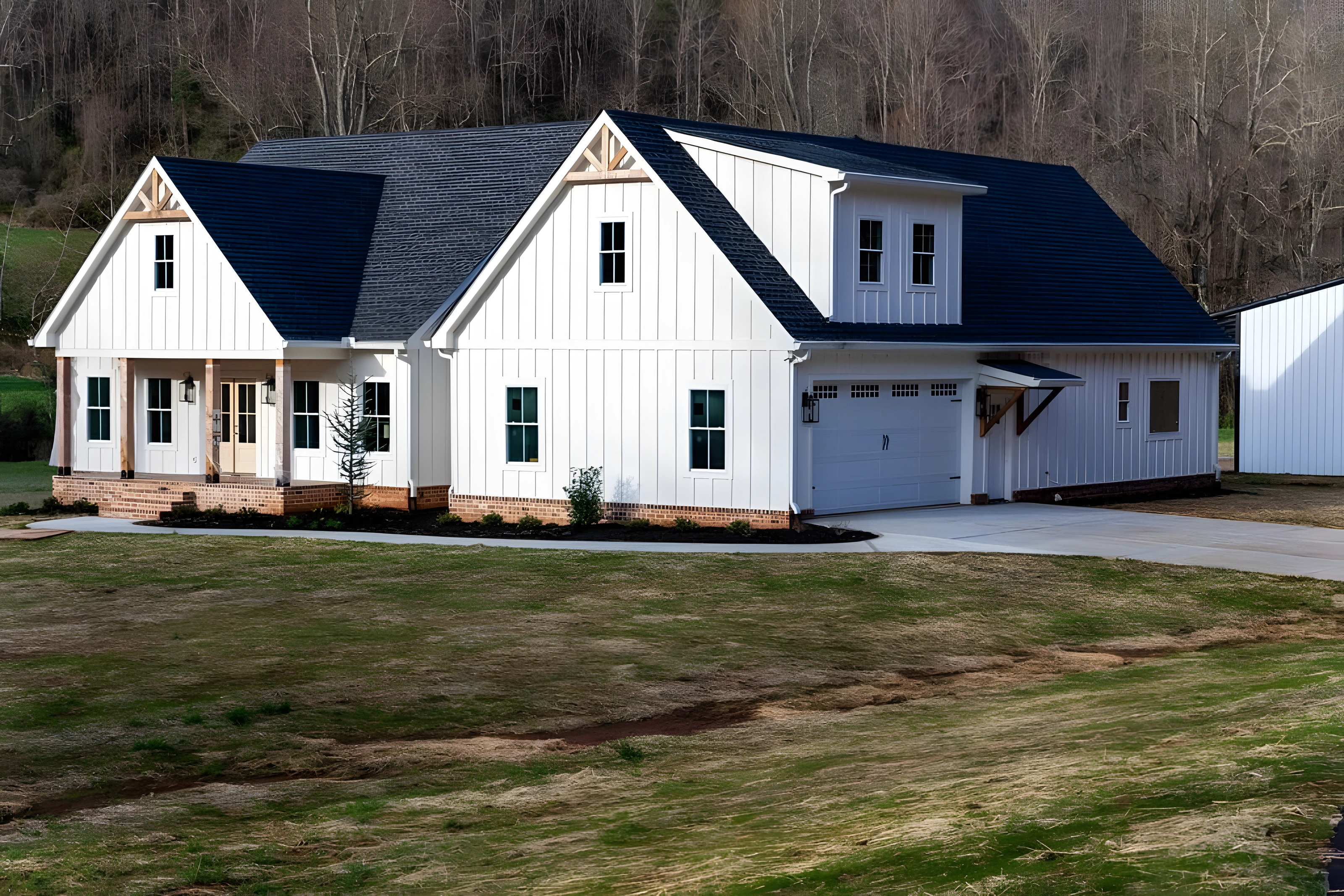 White farmhouse with covered porch built by Lanier Home Builders